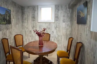 a dining room table with a vase of flowers on it at Casa Larán in Chantada