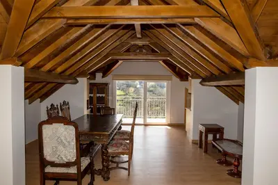 a dining room with a wooden ceiling with beams at Casa Saborido in Chantada