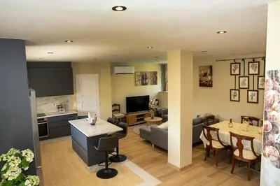 a living room with a kitchen and a dining room at Casa Saborido in Chantada