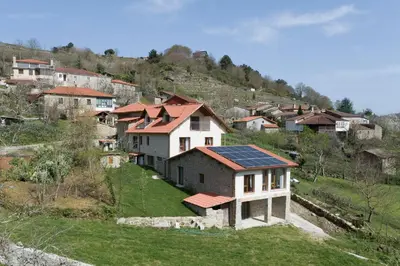 a group of houses with solar panels on a hill at Casa Saborido in Chantada