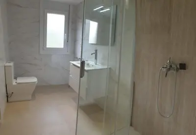 a bathroom with a shower and a toilet and a sink at Casa Saborido in Chantada