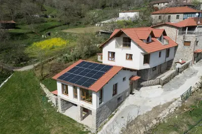 a house with a solar array on its roof at Casa da Cocha in Chantada