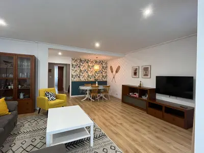 a living room with a couch and a tv at Piso en Ourense- Sempre Maruxiña in Ourense