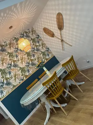 a table and chairs with a surfboard on the wall at Piso en Ourense- Sempre Maruxiña in Ourense