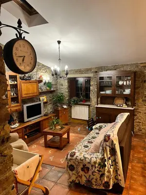a living room with a clock on the wall at CASA GALLARDO in Ribadeo