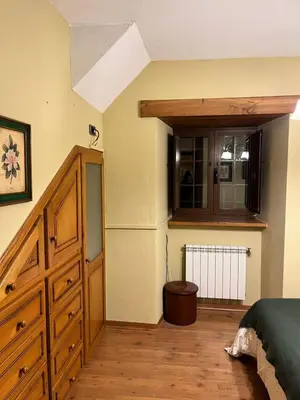 a bedroom with a bed and a wooden dresser at CASA GALLARDO in Ribadeo