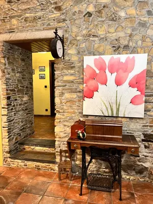 a piano in a room with a painting on the wall at CASA GALLARDO in Ribadeo