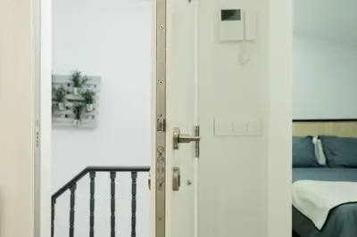 a door leading to a bedroom with a bed at Ático Isabel, diseño y calidez junto a la Muralla Romana in Lugo