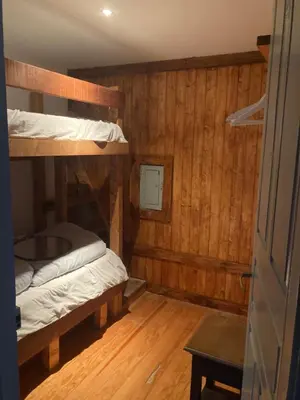 a room with two bunk beds and a door at Casa de las Ascuas in Ourense