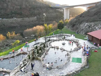 a group of people in a pond in a river at Casa de las Ascuas in Ourense