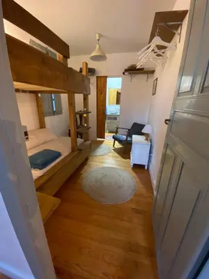 a room with a bunk bed and a room with a door at Casa de las Ascuas in Ourense