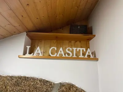 a wooden sign that says la casa on a wall at La Casita in Nogueira de Ramuin