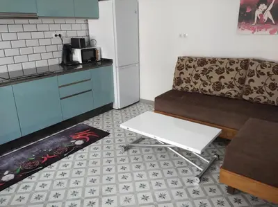 a kitchen with a couch and a table at A Travesía Dos Soños, Pedreiras in Sarria