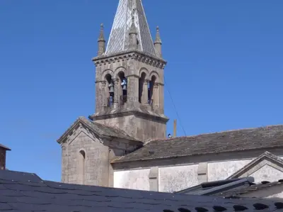 an old church with a tower with a clock on it at A Travesía Dos Soños, Pedreiras in Sarria