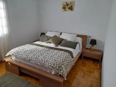 a bedroom with a large bed with two night stands at O Monteiriño in Arbo