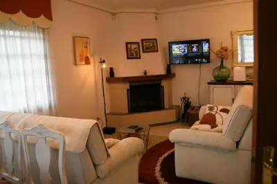 a living room with two chairs and a tv at O Monteiriño in Arbo