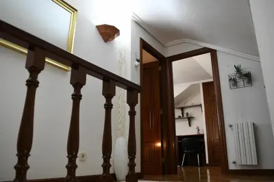 a hallway with a staircase with a door and a desk at O Monteiriño in Arbo