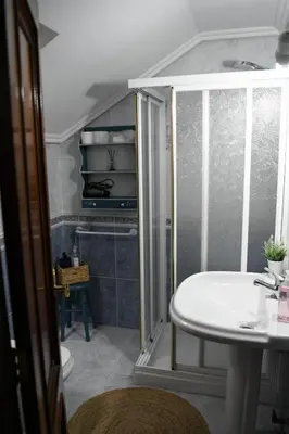 a bathroom with a shower and a white sink at O Monteiriño in Arbo