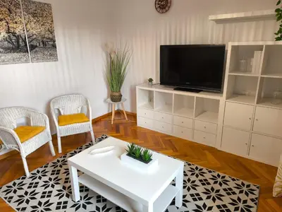 a living room with a tv and a white coffee table at Los Hidalgos de Lemos in Monforte de Lemos