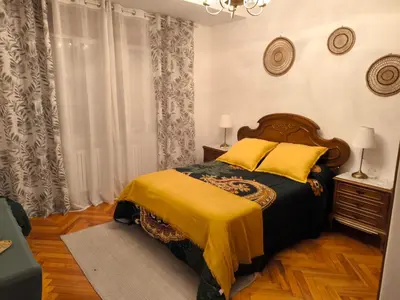 a bedroom with a bed with a yellow blanket at Los Hidalgos de Lemos in Monforte de Lemos