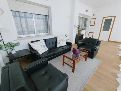 a living room with a black couch and chairs at Los Hidalgos de Lemos in Monforte de Lemos