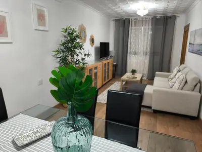 a living room with a vase on a glass table at Los Hidalgos de Lemos in Monforte de Lemos