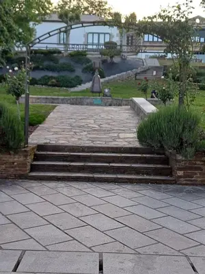 a set of stairs in a garden with grass at Apartamentos O Caneiro in Portomarin