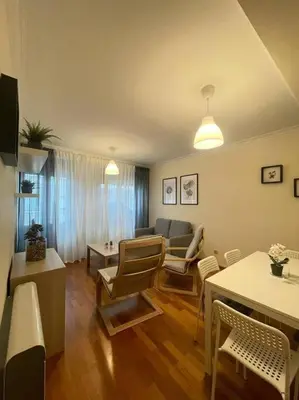 a living room with a couch and a table and chairs at Apartamento con encanto en Cuntis in Cuntis