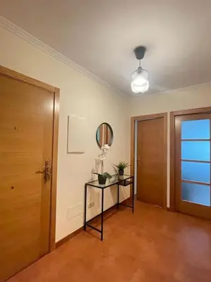 a room with a door and a table with a mirror at Apartamento con encanto en Cuntis in Cuntis