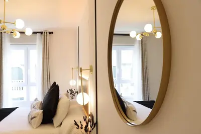 a bedroom with a mirror and a bed at Apartamento Exclusivo Céntrico con parking Estrella de Ribadeo II in Ribadeo