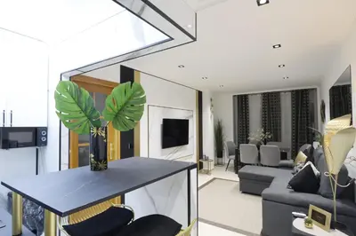 a living room with a couch and a table with a plant at Apartamento Exclusivo Céntrico con parking Estrella de Ribadeo II in Ribadeo