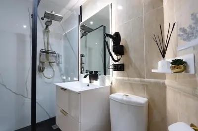 a bathroom with a toilet and a sink and a shower at Apartamento Exclusivo Céntrico con parking Estrella de Ribadeo II in Ribadeo