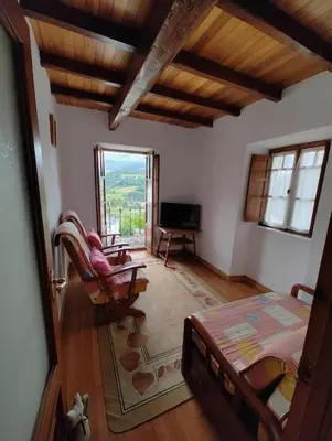 a room with a bedroom with a bed and a television at Villa Doiras in Boal