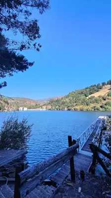 a view of a lake with a wooden dock at Villa Doiras in Boal