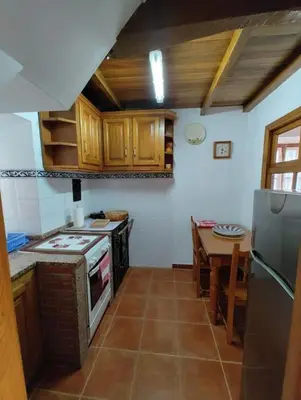 a kitchen with a stove and a table in it at Villa Doiras in Boal
