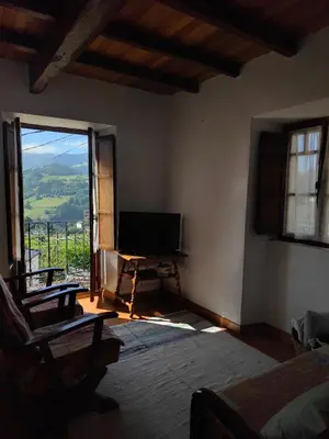 a bedroom with a television and a large window at Villa Doiras in Boal