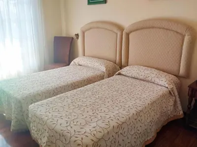 two beds sitting next to each other in a bedroom at Casa Sanmartín in Maside