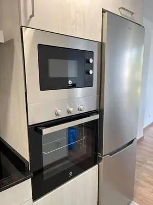 a stainless steel oven with a microwave in a kitchen at Apartamento céntrico con vistas in Santiago de Compostela