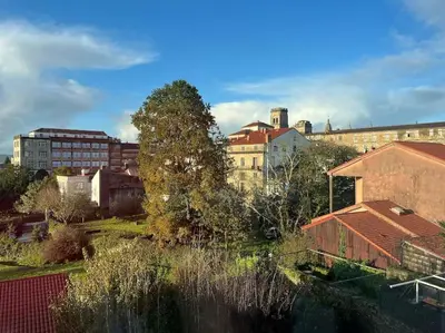 a view of a city with buildings and trees at Apartamento céntrico con vistas in Santiago de Compostela