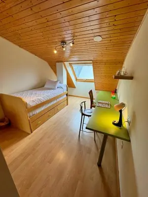 a small room with a bed and a table at Orbayu apartamento Foz in Foz