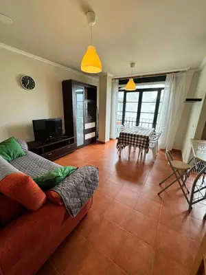 a living room with a couch and a table at Orbayu apartamento Foz in Foz