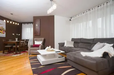 a living room with a couch and a table at Alojamiento Santa Maria in Milladoiro