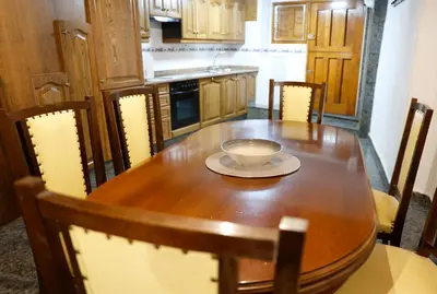 a kitchen with a wooden table with a bowl on it at A casa do pozo - AS CASAS DO POZO - in Folgoso