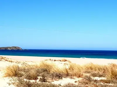 a sandy beach with the ocean in the background at Casa Natura Galicia in Santa María La Mayor del Rosario