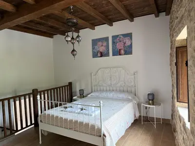 a bedroom with a bed and two pictures on the wall at Arteleira2 Rooms in Padrón