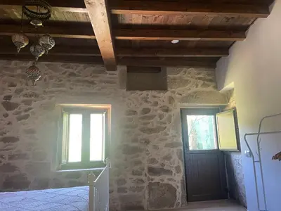 a room with two windows and a black door at Arteleira2 Rooms in Padrón
