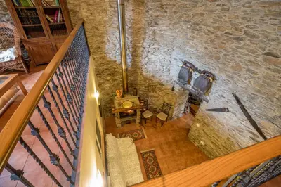 an overhead view of a room with a stone wall at Casa Rural La Fuente in Tejedo del Sil