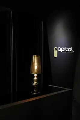 a lamp sitting on a table in front of a sign at Capitol Boutique Hotel in Santiago de Compostela