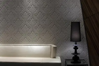 a room with a bed and a lamp on a wall at Capitol Boutique Hotel in Santiago de Compostela