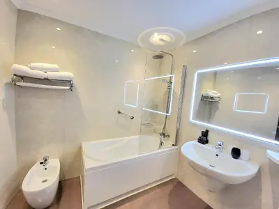 a bathroom with a sink and a tub and a toilet at Capitol Boutique Hotel in Santiago de Compostela